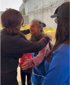 Cindy Tyeskey-Gage embracing the family receiving the new home